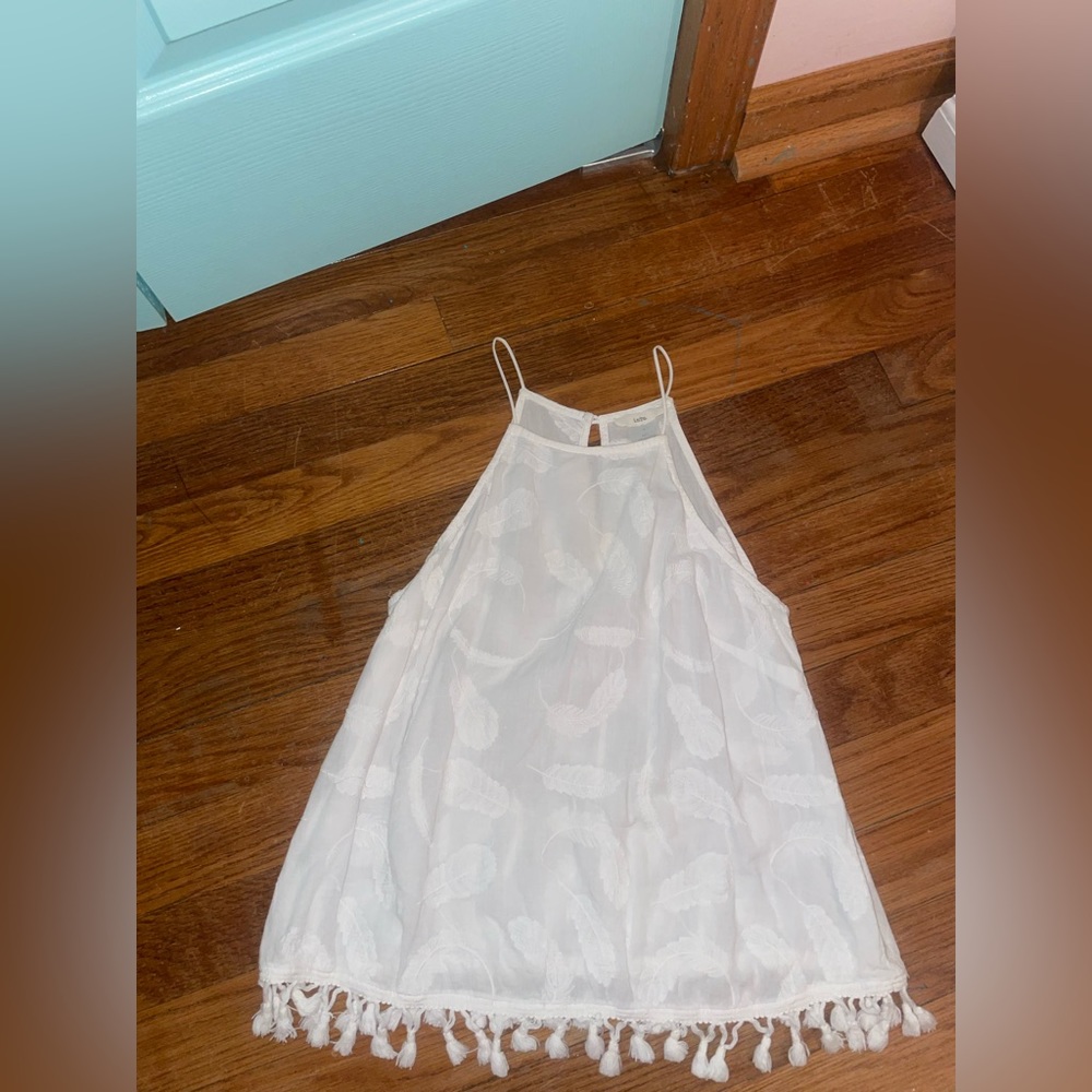 White sleeveless top with feather embroidery detail